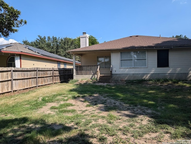 back of property featuring a lawn