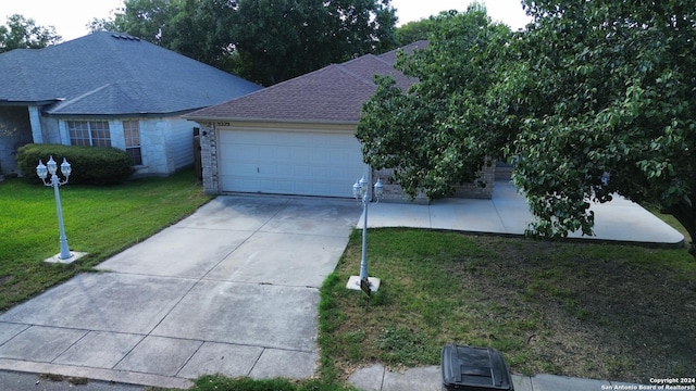 view of front of property with a garage and a front yard