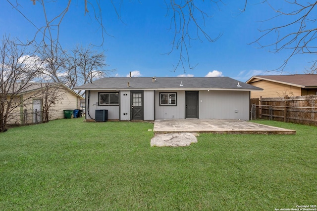 back of property with central AC unit, a yard, and a patio area