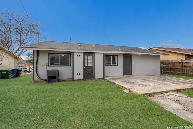 rear view of property featuring central air condition unit, a yard, and a patio area