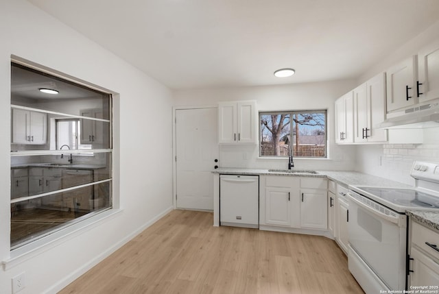 kitchen with white appliances, white cabinetry, sink, and backsplash