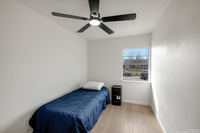 bedroom with ceiling fan and light hardwood / wood-style floors