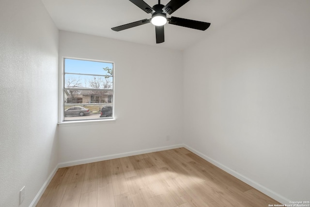 spare room with light wood-type flooring and ceiling fan