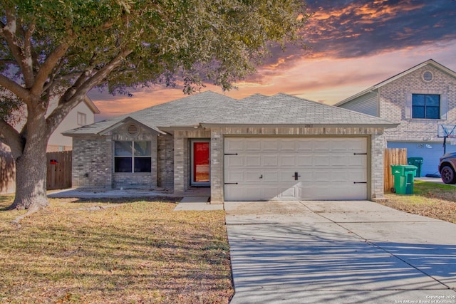 view of front of property featuring a garage and a lawn