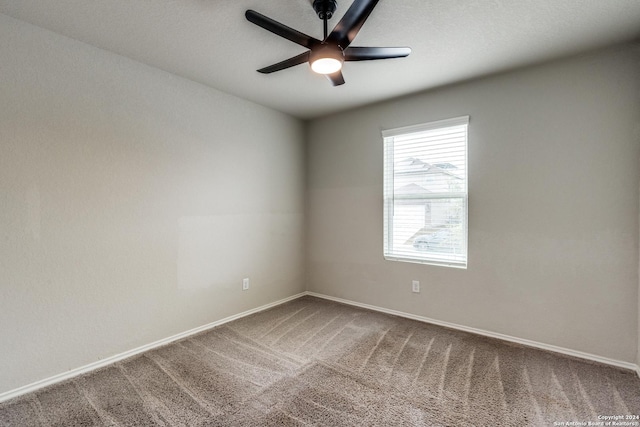 spare room featuring baseboards, a ceiling fan, and carpet flooring