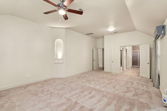 unfurnished bedroom featuring lofted ceiling, light carpet, a wall mounted AC, and visible vents