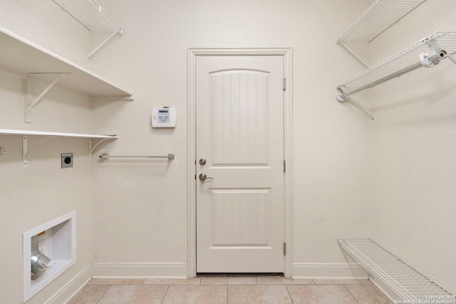 laundry room featuring baseboards, light tile patterned flooring, laundry area, and electric dryer hookup