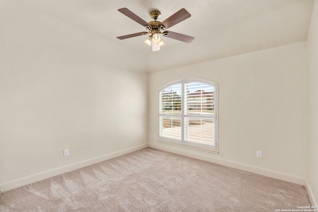 empty room featuring light carpet, baseboards, and ceiling fan