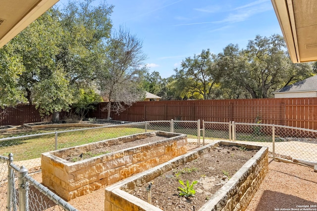 view of yard featuring a vegetable garden and a fenced backyard