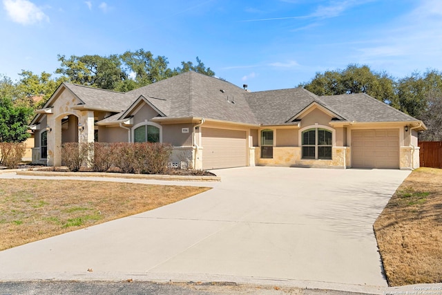 ranch-style house with stucco siding, a garage, a shingled roof, and concrete driveway