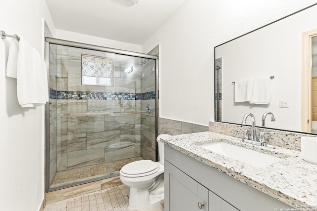 bathroom with toilet, walk in shower, and vanity