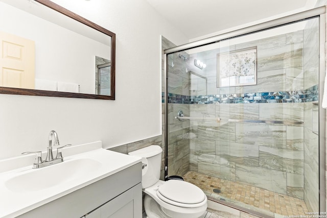 bathroom with vanity, toilet, and an enclosed shower