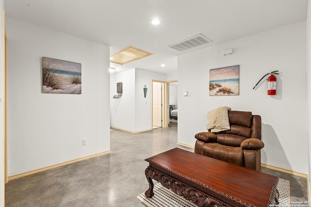 living area with concrete flooring