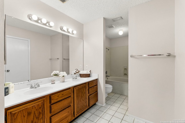 full bathroom with a sink, toilet, tile patterned flooring, and a textured ceiling