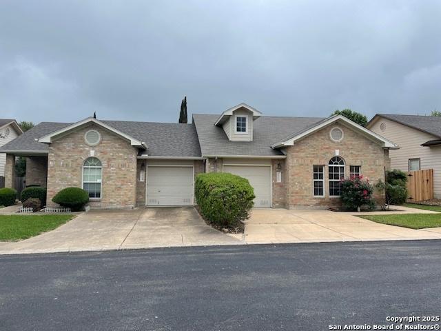 7723 Wexford Rdg, San Antonio, TX 78240 - view of front of house featuring brick siding, driveway, and a garage