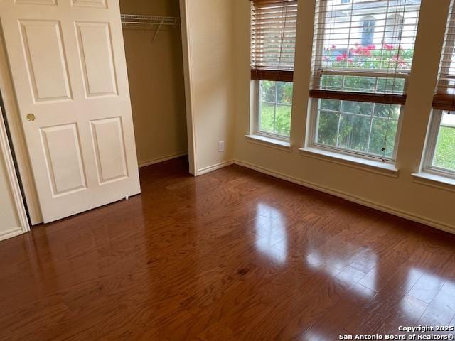 7723 Wexford Rdg, San Antonio, TX 78240 - unfurnished bedroom featuring baseboards, dark wood-style flooring, and a closet