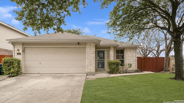 single story home with fence, stone siding, driveway, a front lawn, and an attached garage