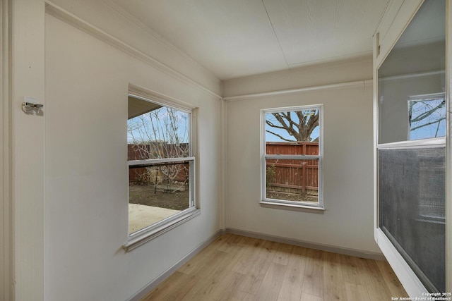 interior space featuring light wood-type flooring and baseboards