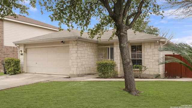 single story home featuring an attached garage, driveway, a front lawn, and stone siding