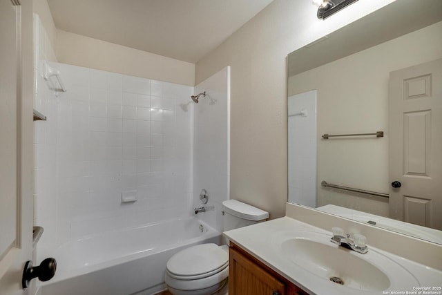 bathroom featuring vanity, tub / shower combination, and toilet