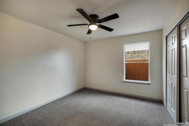 unfurnished bedroom with baseboards, a ceiling fan, a closet, and carpet floors