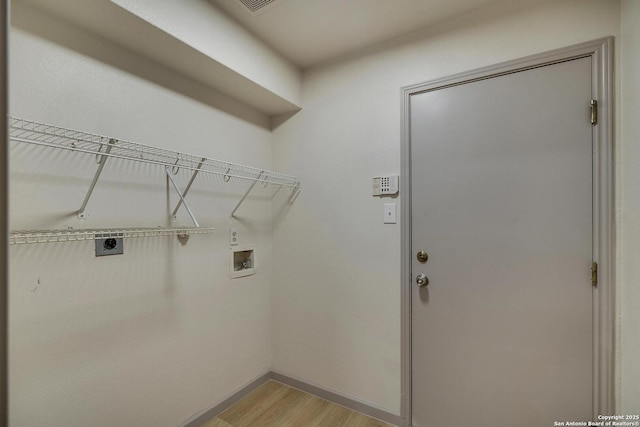 laundry room featuring washer hookup, light wood finished floors, electric dryer hookup, laundry area, and baseboards