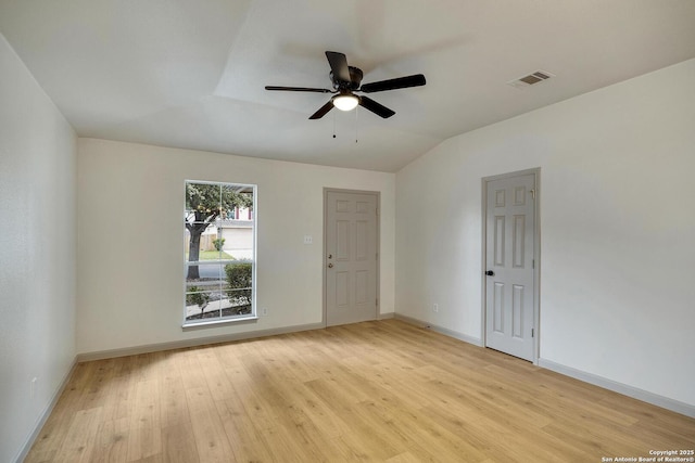 unfurnished room with baseboards, visible vents, lofted ceiling, light wood-type flooring, and ceiling fan