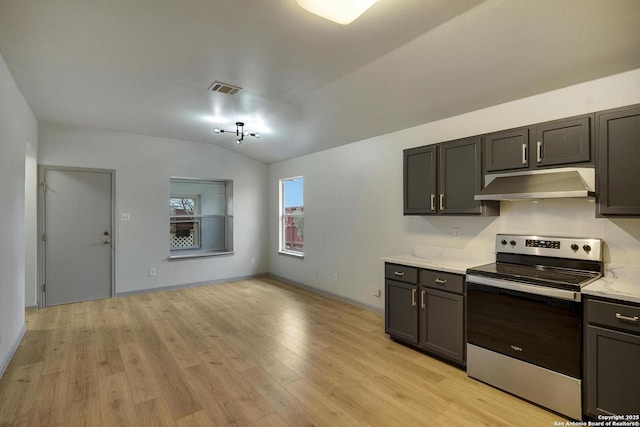 kitchen featuring visible vents, stainless steel electric range, light wood-type flooring, vaulted ceiling, and under cabinet range hood