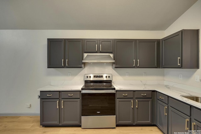 kitchen featuring light wood-style flooring, stainless steel range with electric stovetop, gray cabinets, and under cabinet range hood