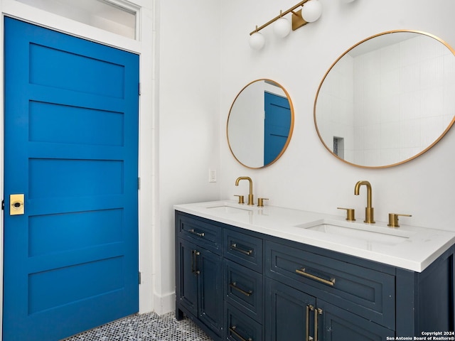 full bathroom with double vanity and a sink