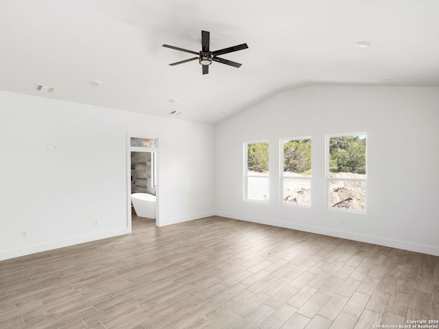 empty room with baseboards, visible vents, lofted ceiling, and light wood-type flooring