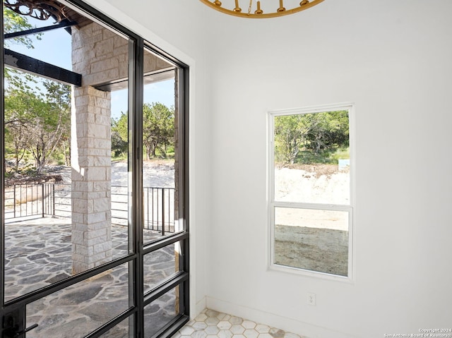 doorway to outside with baseboards