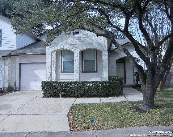 6111 Wexford Pl, San Antonio, TX 78240 - view of front of house with driveway, stone siding, and a garage