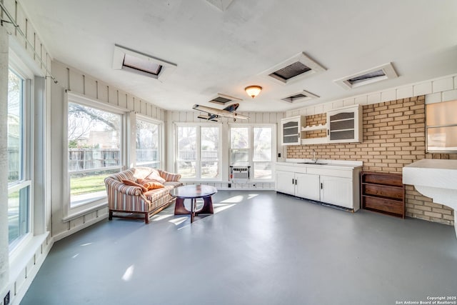 sunroom featuring a sink