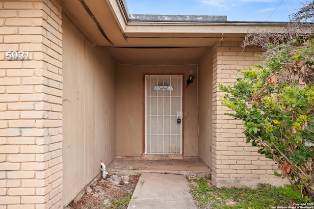 property entrance with brick siding