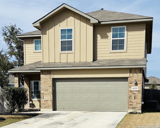 traditional-style house with a garage, driveway, board and batten siding, and brick siding