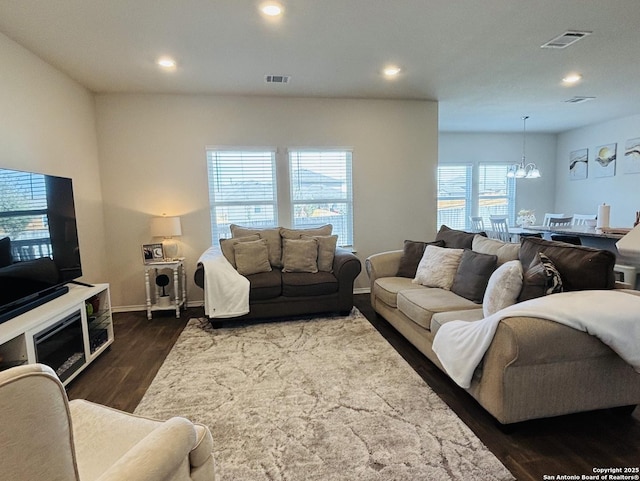 living room featuring an inviting chandelier, visible vents, dark wood-style flooring, and recessed lighting