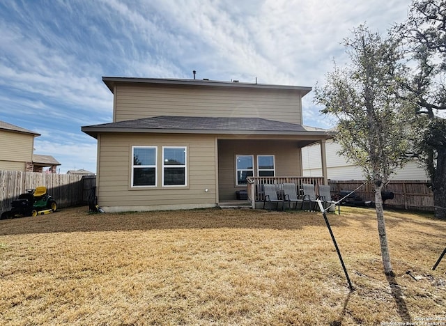 rear view of property with a lawn, a fenced backyard, and a wooden deck