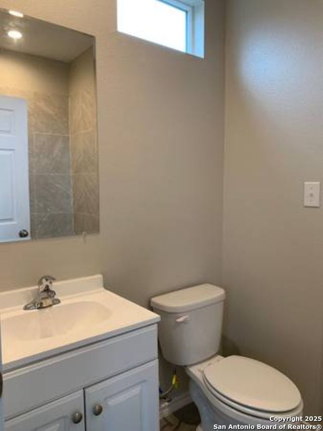 bathroom with toilet and vanity