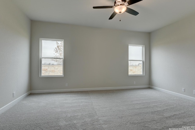 unfurnished room featuring ceiling fan, baseboards, and light colored carpet