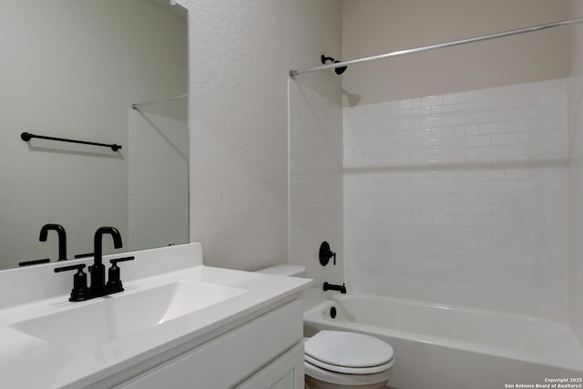 full bath with toilet, a textured wall, tub / shower combination, and vanity