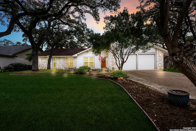 view of front of property with a garage, stone siding, a front yard, and driveway