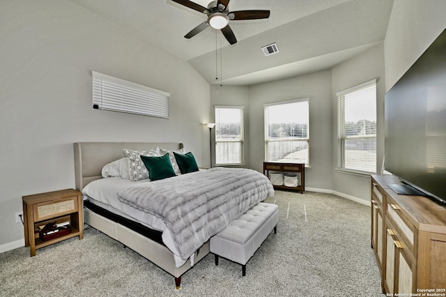 bedroom featuring visible vents, baseboards, vaulted ceiling, and light colored carpet