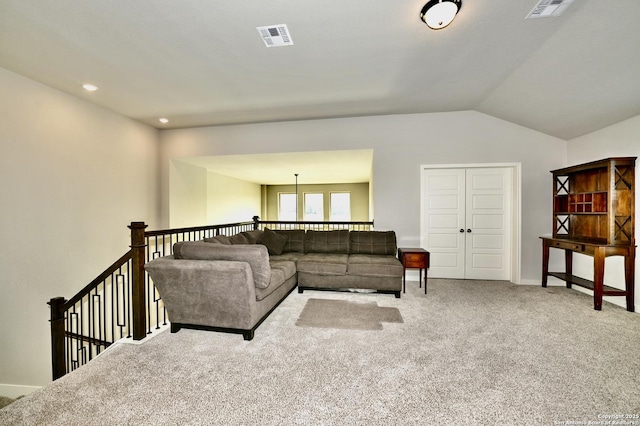 living room with light colored carpet, visible vents, vaulted ceiling, and baseboards