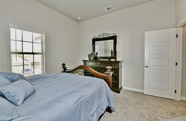 bedroom featuring baseboards, visible vents, and light colored carpet