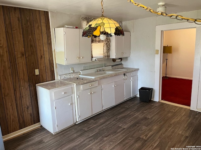 kitchen featuring white cabinets, dark wood-style flooring, pendant lighting, and light countertops