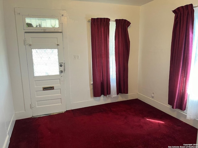 carpeted foyer entrance with baseboards