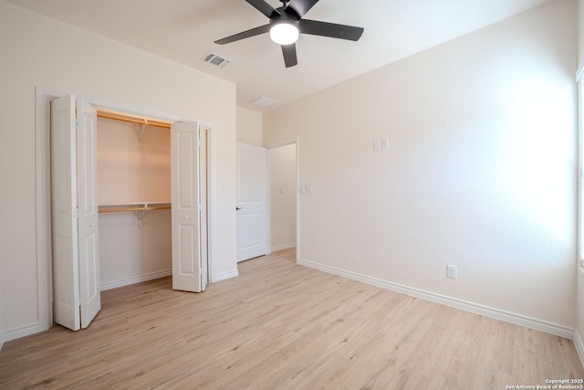 unfurnished bedroom with visible vents, light wood-style flooring, and baseboards