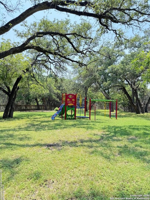 community jungle gym with a lawn