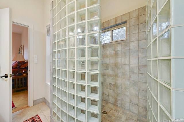 bathroom with tile patterned flooring and walk in shower